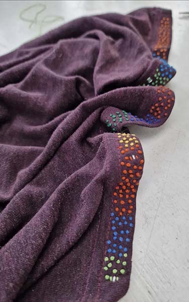 A purple skirt embroidered on the hem with French knots|376